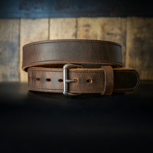 a leather belt on a black surface
